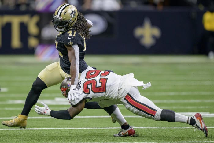 New Orleans Saints running back Alvin Kamara (41) runs against Tampa Bay Buccaneers safety Christian Izien (29). Mandatory Credit: Matthew Hinton-USA TODAY Sports